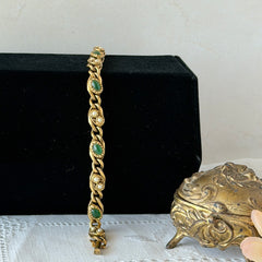 Vintage Goldette N.Y. bracelet with alternating green cabochons and faux pearls in textured gold‑tone curb links, fold‑over clasp signed Goldette N.Y.