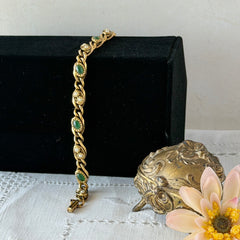 Vintage Goldette N.Y. bracelet with alternating green cabochons and faux pearls in textured gold‑tone curb links, fold‑over clasp signed Goldette N.Y.