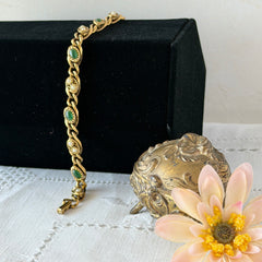 Vintage Goldette N.Y. bracelet with alternating green cabochons and faux pearls in textured gold‑tone curb links, fold‑over clasp signed Goldette N.Y.