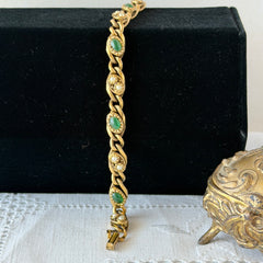 Vintage Goldette N.Y. bracelet with alternating green cabochons and faux pearls in textured gold‑tone curb links, fold‑over clasp signed Goldette N.Y.