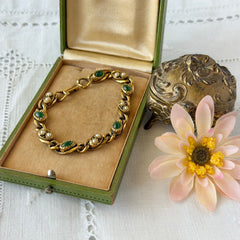 Vintage Goldette N.Y. bracelet with alternating green cabochons and faux pearls in textured gold‑tone curb links, fold‑over clasp signed Goldette N.Y.