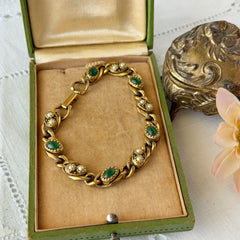 Vintage Goldette N.Y. bracelet with alternating green cabochons and faux pearls in textured gold‑tone curb links, fold‑over clasp signed Goldette N.Y.