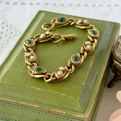 Vintage Goldette N.Y. bracelet with alternating green cabochons and faux pearls in textured gold‑tone curb links, fold‑over clasp signed Goldette N.Y.