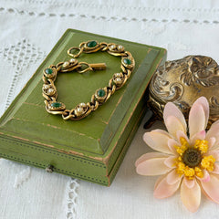 Vintage Goldette N.Y. bracelet with alternating green cabochons and faux pearls in textured gold‑tone curb links, fold‑over clasp signed Goldette N.Y.