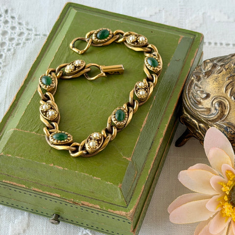 Vintage Goldette N.Y. bracelet with alternating green cabochons and faux pearls in textured gold‑tone curb links, fold‑over clasp signed Goldette N.Y.
