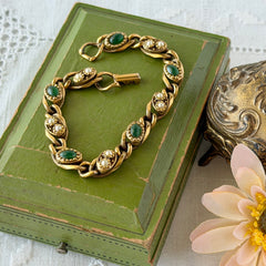 Vintage Goldette N.Y. bracelet with alternating green cabochons and faux pearls in textured gold‑tone curb links, fold‑over clasp signed Goldette N.Y.