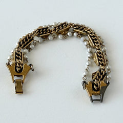 Vintage Goldette NY Victorian Revival bracelet with faux pearls, floral and animal motifs, cameo, and gold‑tone links showing gentle patina.