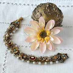 Vintage Goldette NY Victorian Revival bracelet with faux pearls, floral and animal motifs, cameo, and gold‑tone links showing gentle patina.