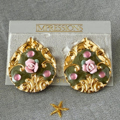Vintage 1980s teardrop post earrings with 3D pink polymer clay rose, green enamel base, and gold tone pressed metal scrollwork on original card.
