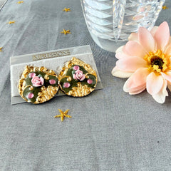 Vintage 1980s teardrop post earrings with 3D pink polymer clay rose, green enamel base, and gold tone pressed metal scrollwork on original card.