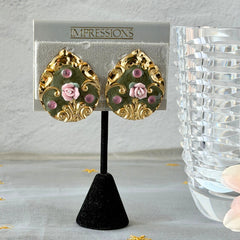 Vintage 1980s teardrop post earrings with 3D pink polymer clay rose, green enamel base, and gold tone pressed metal scrollwork on original card.