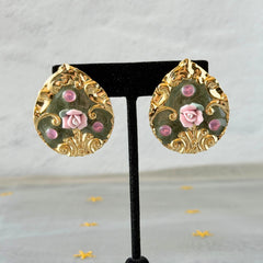 Vintage 1980s teardrop post earrings with 3D pink polymer clay rose, green enamel base, and gold tone pressed metal scrollwork on original card.