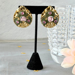 Vintage 1980s teardrop post earrings with 3D pink polymer clay rose, green enamel base, and gold tone pressed metal scrollwork on original card.
