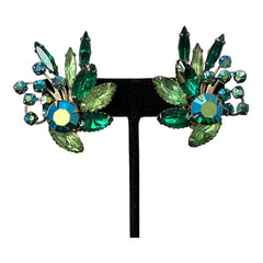Vintage 1960s clip-on floral earrings with green and iridescent rhinestones in chaton, navette, and marquise cuts, set in gold-tone metal—sparkling midcentury costume jewelry in very good condition.