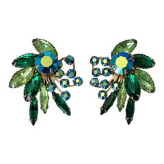 Vintage 1960s clip-on floral earrings with green and iridescent rhinestones in chaton, navette, and marquise cuts, set in gold-tone metal—sparkling midcentury costume jewelry in very good condition.