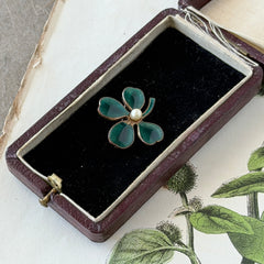 Vintage green guilloché enamel four‑leaf clover brooch with faux pearl center and rose gold tone finish.