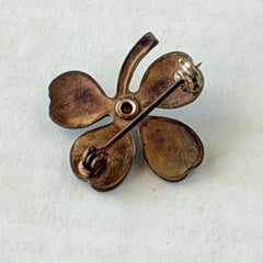 Vintage green guilloché enamel four‑leaf clover brooch with faux pearl center and rose gold tone finish.