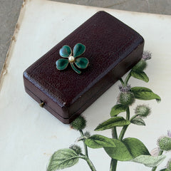 Vintage green guilloché enamel four‑leaf clover brooch with faux pearl center and rose gold tone finish.