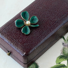Vintage green guilloché enamel four‑leaf clover brooch with faux pearl center and rose gold tone finish.