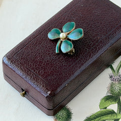 Vintage green guilloché enamel four‑leaf clover brooch with faux pearl center and rose gold tone finish.