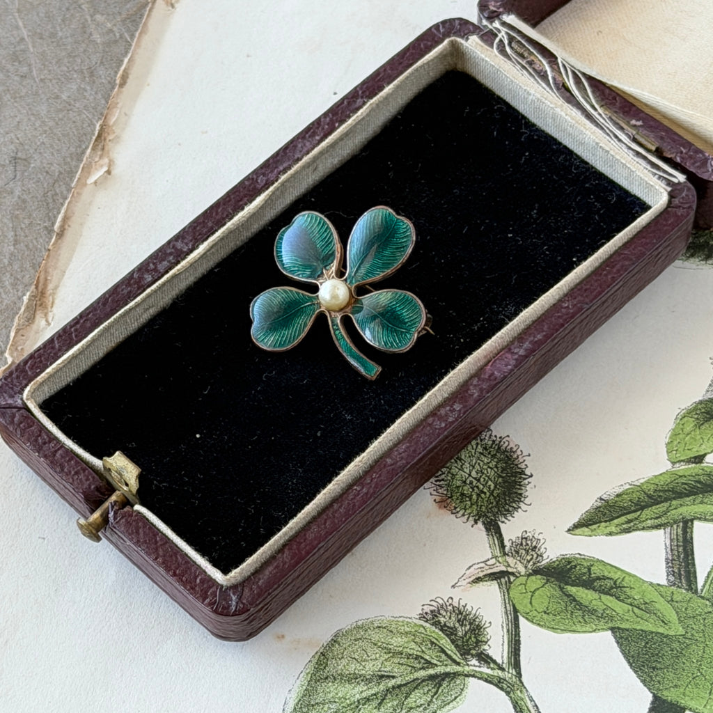 Vintage green guilloché enamel four‑leaf clover brooch with faux pearl center and rose gold tone finish.