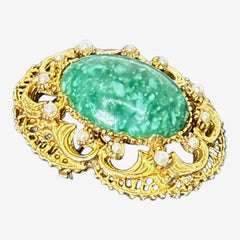 Vintage brooch pendant with mottled green glass cabochon, faux pearls, and ornate gold tone filigree, photographed front and back to highlight its 1960s–70s revival style and dual-wear functionality.