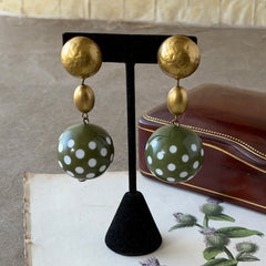 Vintage 1980s green and white polka‑dot plastic ball dangle gold tone statement clip‑on earrings.