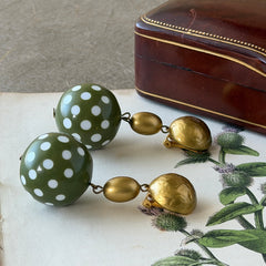 Vintage 1980s green and white polka‑dot plastic ball dangle gold tone statement clip‑on earrings.