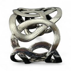 Textured dark silver tone cuff bracelet with interwoven, ribbon-like bands forming a sculptural openwork design; hammered finish adds depth and dimension to the modern, unsigned piece.