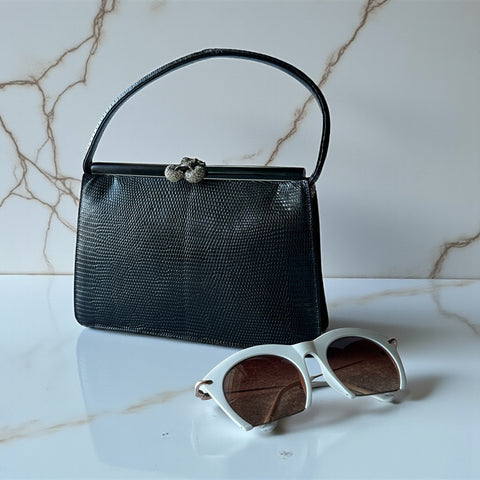 Vintage black Harry Rosenfeld handbag made of mixed exotic skins with a textured body, curved exotic-skin handle, and pavé rhinestone fruit clasp, shown from various angles including the satin-lined interior with signature label.