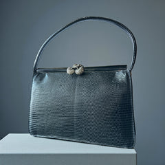 Vintage black Harry Rosenfeld handbag made of mixed exotic skins with a textured body, curved exotic-skin handle, and pavé rhinestone fruit clasp, shown from various angles including the satin-lined interior with signature label.