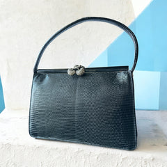 Vintage black Harry Rosenfeld handbag made of mixed exotic skins with a textured body, curved exotic-skin handle, and pavé rhinestone fruit clasp, shown from various angles including the satin-lined interior with signature label.