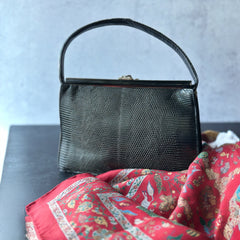 Vintage black Harry Rosenfeld handbag made of mixed exotic skins with a textured body, curved exotic-skin handle, and pavé rhinestone fruit clasp, shown from various angles including the satin-lined interior with signature label.