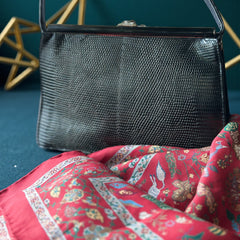 Vintage black Harry Rosenfeld handbag made of mixed exotic skins with a textured body, curved exotic-skin handle, and pavé rhinestone fruit clasp, shown from various angles including the satin-lined interior with signature label.