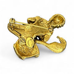 Vintage Hattie Carnegie snake charmer brooch with turquoise cabochons and blue rhinestones, gold tone metal, signed with copyright mark, 1960s figural costume jewelry.