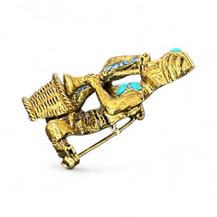 Vintage Hattie Carnegie snake charmer brooch with turquoise cabochons and blue rhinestones, gold tone metal, signed with copyright mark, 1960s figural costume jewelry.