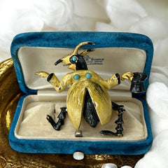 Signed Hattie Carnegie vintage bug brooch with yellow enamel coat, black top hat, turquoise cabochons, and gold-tone details—whimsical mid-century costume jewelry