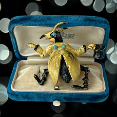 Signed Hattie Carnegie vintage bug brooch with yellow enamel coat, black top hat, turquoise cabochons, and gold-tone details—whimsical mid-century costume jewelry