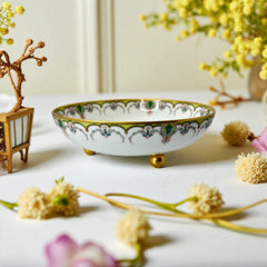 Antique Haviland Limoges France porcelain serving bowl with three gold spherical feet, ornate rim featuring floral and scroll motifs in blue, green, red, and gold; white base with maker’s marks “Haviland France” and “Haviland & Co Limoges”; very good vintage condition with one small factory flaw in center
