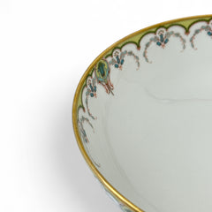 Antique Haviland Limoges France porcelain serving bowl with three gold spherical feet, ornate rim featuring floral and scroll motifs in blue, green, red, and gold; white base with maker’s marks “Haviland France” and “Haviland & Co Limoges”; very good vintage condition with one small factory flaw in center