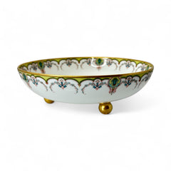 Antique Haviland Limoges France porcelain serving bowl with three gold spherical feet, ornate rim featuring floral and scroll motifs in blue, green, red, and gold; white base with maker’s marks “Haviland France” and “Haviland & Co Limoges”; very good vintage condition with one small factory flaw in center