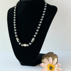 Vintage hematite bead necklace with gold‑tone and silver‑tone accents, hand‑knotted with slide ball clasp.