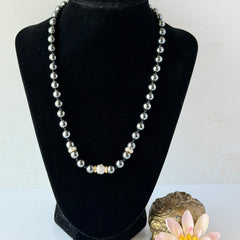 Vintage hematite bead necklace with gold‑tone and silver‑tone accents, hand‑knotted with slide ball clasp.