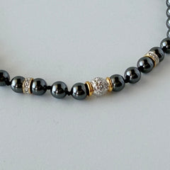 Vintage hematite bead necklace with gold‑tone and silver‑tone accents, hand‑knotted with slide ball clasp.