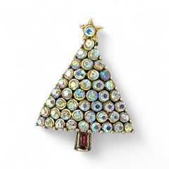 Vintage Hollycraft Christmas tree brooch with clear Aurora Borealis rhinestones in a gold-tone setting, featuring a gold star at the top and a red rhinestone base. Signed on the reverse and measuring approximately 1 3/8 inches tall by 1 inch wide.