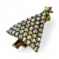 Vintage Hollycraft Christmas tree brooch with clear Aurora Borealis rhinestones in a gold-tone setting, featuring a gold star at the top and a red rhinestone base. Signed on the reverse and measuring approximately 1 3/8 inches tall by 1 inch wide.