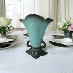 Vintage Hull Pottery vase with scalloped rim, aqua and speckled green glaze, double handles, and flared silhouette, photographed to highlight its mid-century design and glossy ceramic finish.