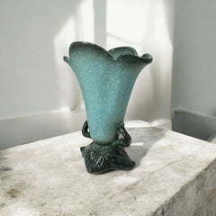 Vintage Hull Pottery vase with scalloped rim, aqua and speckled green glaze, double handles, and flared silhouette, photographed to highlight its mid-century design and glossy ceramic finish.