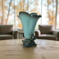 Vintage Hull Pottery vase with scalloped rim, aqua and speckled green glaze, double handles, and flared silhouette, photographed to highlight its mid-century design and glossy ceramic finish.