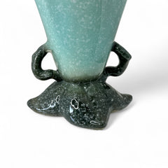 Vintage Hull Pottery vase with scalloped rim, aqua and speckled green glaze, double handles, and flared silhouette, photographed to highlight its mid-century design and glossy ceramic finish.